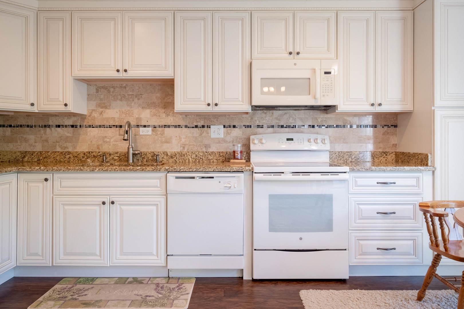 335 Shadow Bend Drive Wheeling, IL 60090 - Photo 5 of 21 a kitchen with granite countertop white cabinets and white appliances
