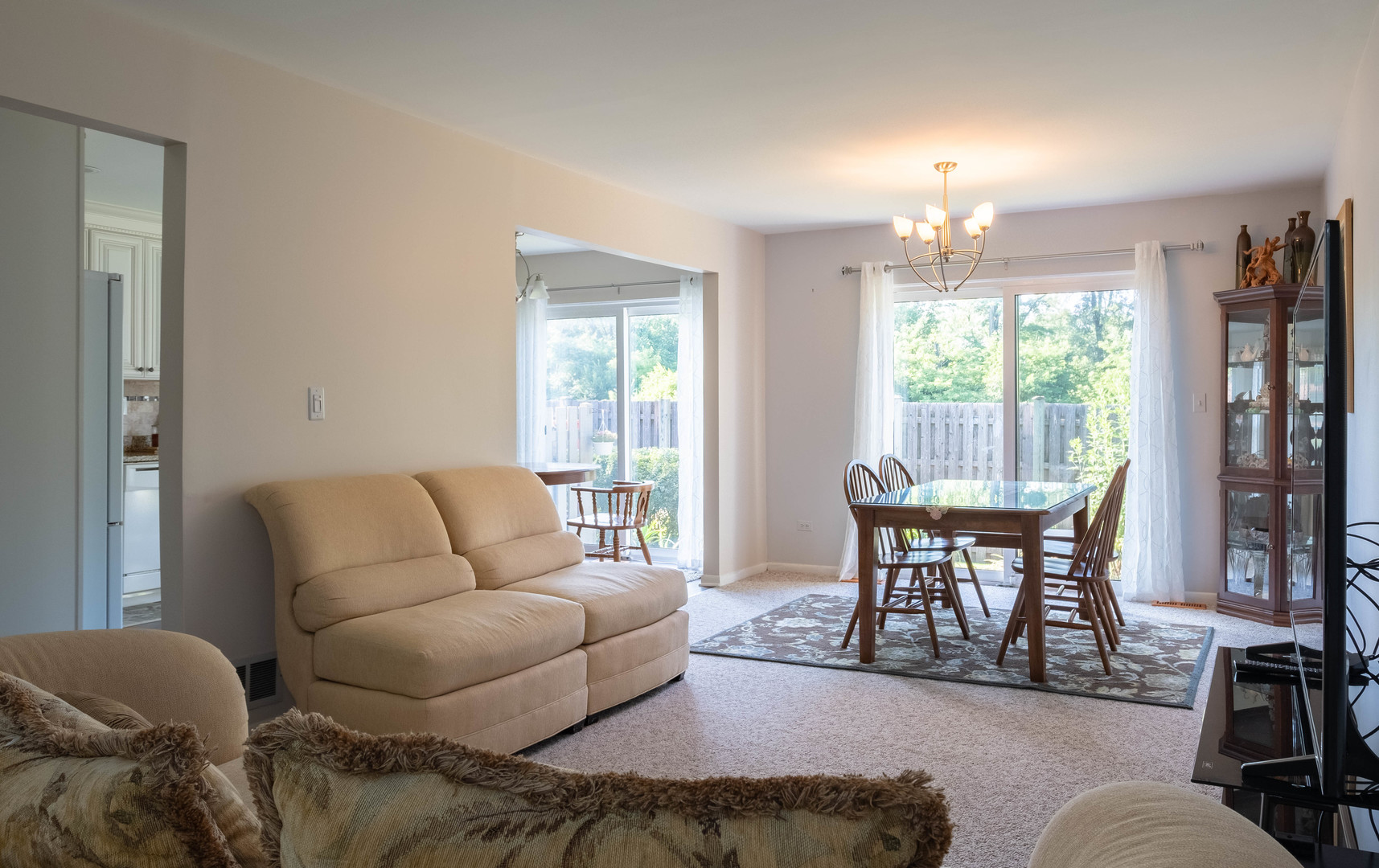 335 Shadow Bend Drive Wheeling, IL 60090 - Photo 7 of 21 a living room with furniture and a chandelier