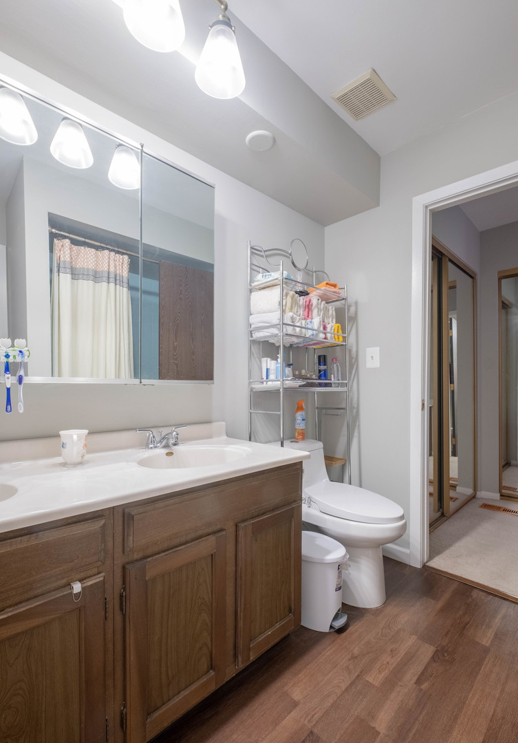335 Shadow Bend Drive Wheeling, IL 60090 - Photo 9 of 21 a bathroom with a sink toilet and a mirror