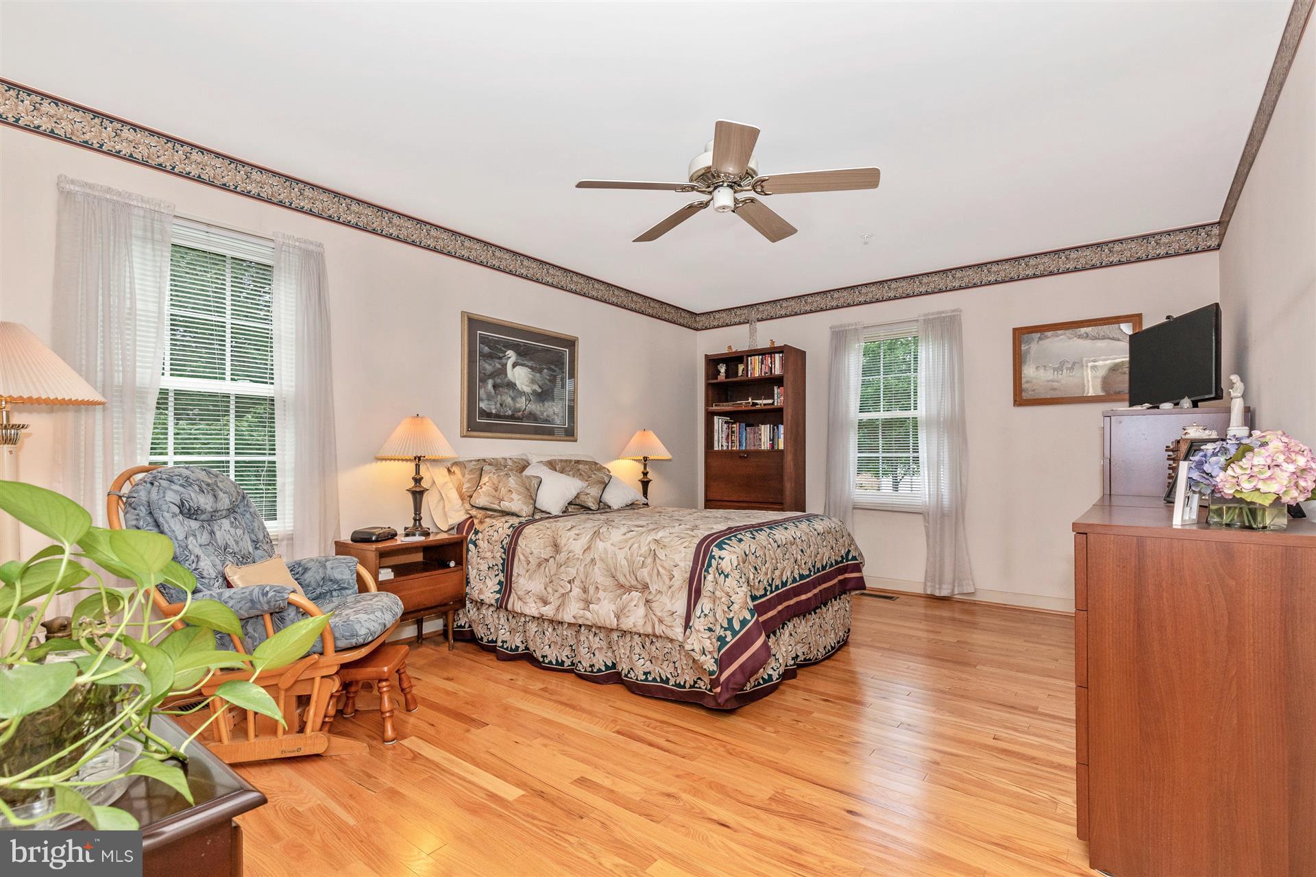 2425 Bear Den Road Frederick, MD 21701 - Photo 14 of 30 a spacious bedroom with a bed couch and a window