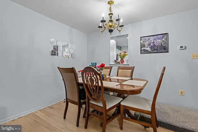 a view of a dining room with furniture wooden floor and a chandelier