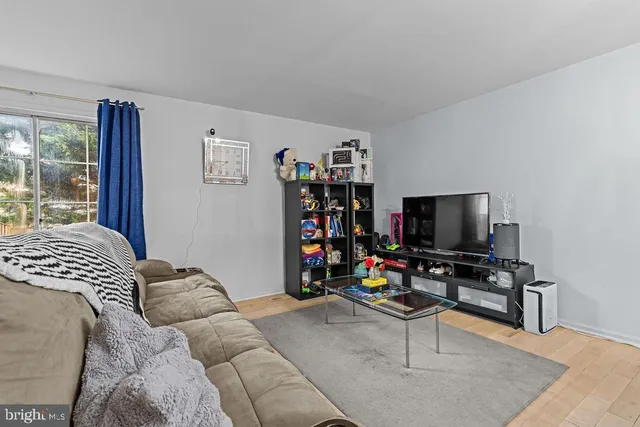 a bedroom with furniture and a flat screen tv