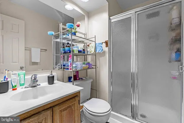 a bathroom with a sink vanity mirror and toilet