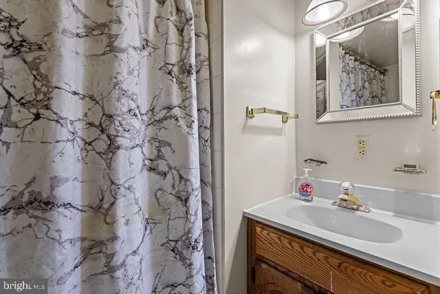 a bathroom with a sink vanity and a mirror