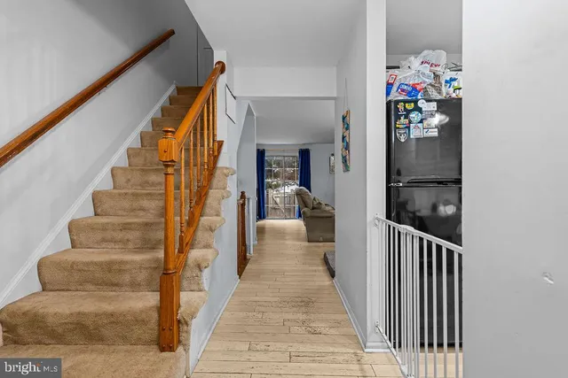 a view of a hallway with wooden floor and entryway