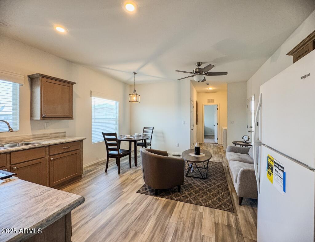 11100 West Alsdorf Road, Unit 66 Arizona City, AZ 85123 - Photo 3 of 7 a kitchen with a table chairs and wooden floor