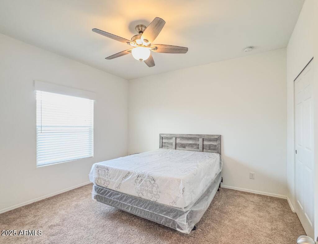 11100 West Alsdorf Road, Unit 66 Arizona City, AZ 85123 - Photo 4 of 7 a bedroom with a bed and a chandelier