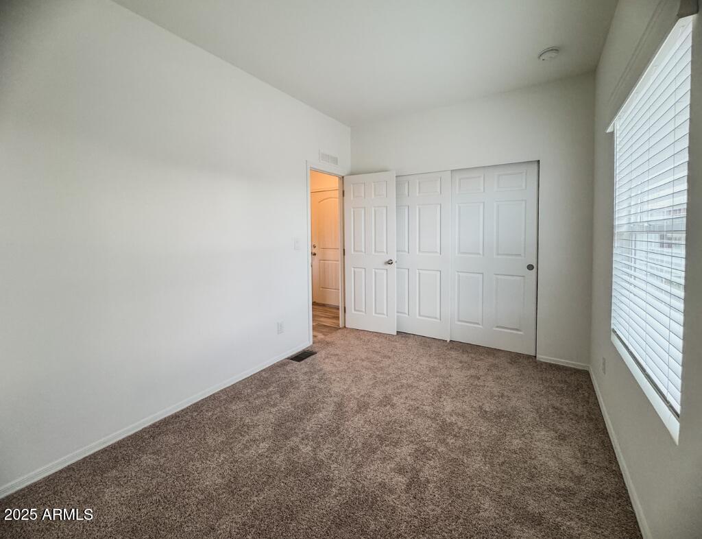 11100 West Alsdorf Road, Unit 66 Arizona City, AZ 85123 - Photo 6 of 7 an empty room with windows