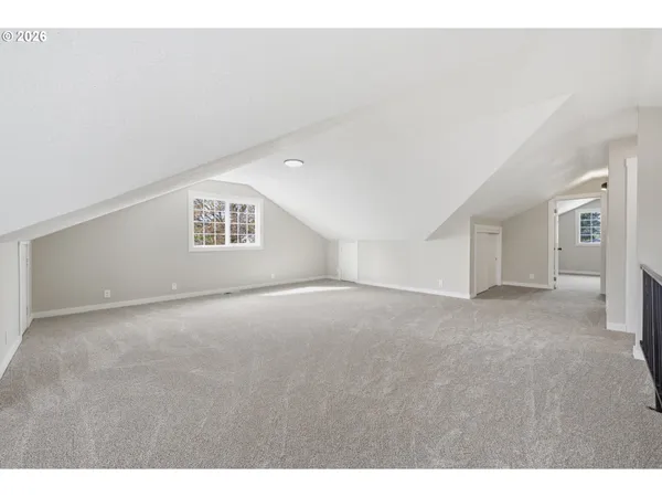 a view of an empty room with a kitchen
