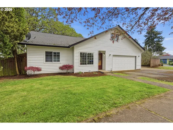 a front view of house with yard and green space