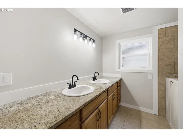 a bathroom with a granite countertop sink a mirror and a