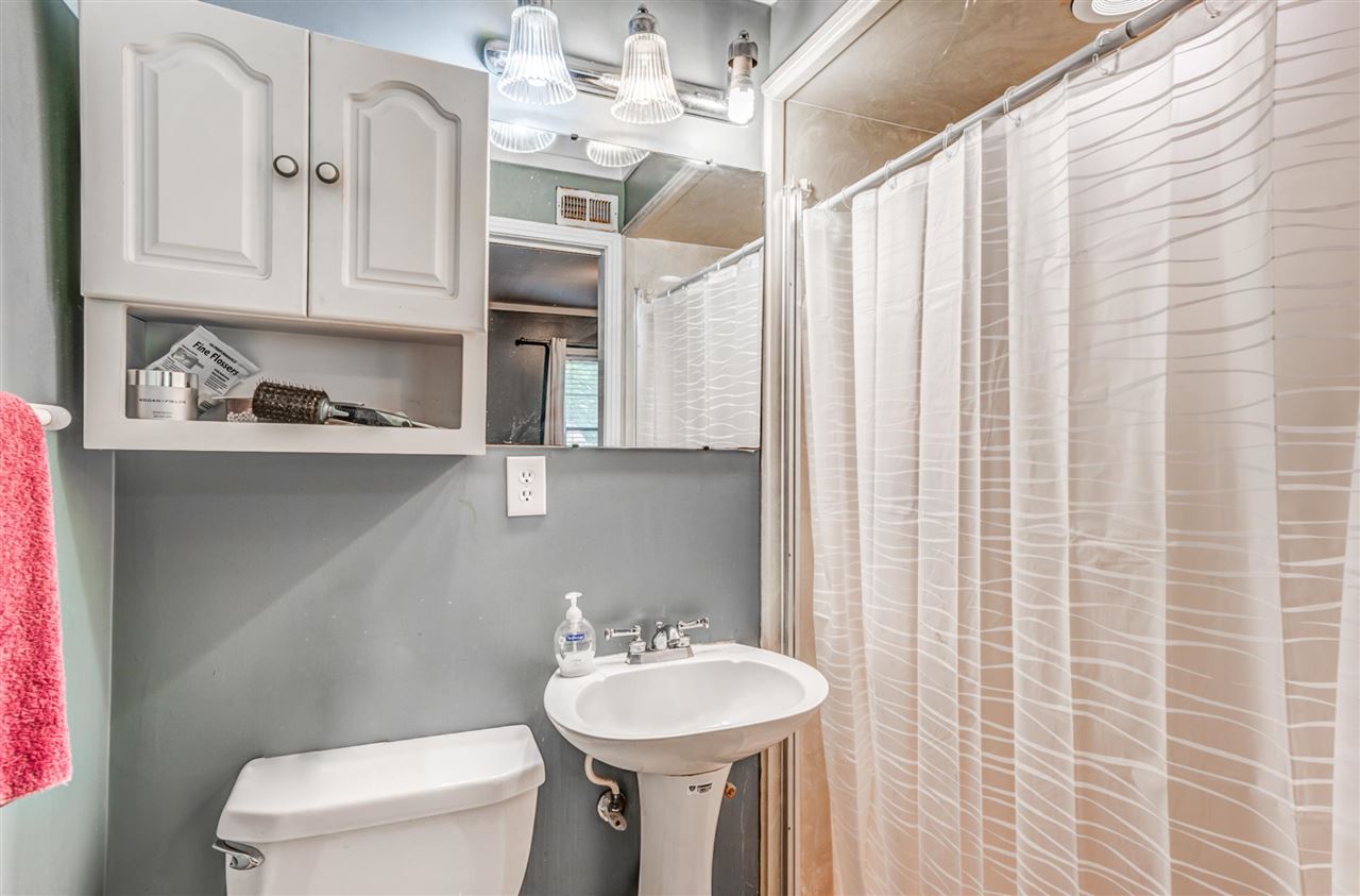 1422 Wilbec Road Memphis, TN 38117 - Photo 13 of 22 a bathroom with a sink a toilet and shower curtain