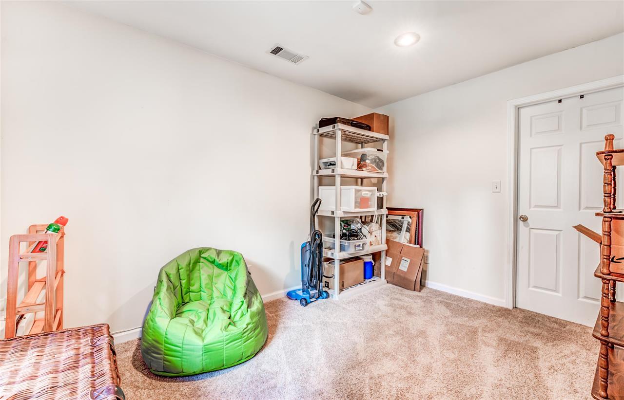 1422 Wilbec Road Memphis, TN 38117 - Photo 17 of 22 a view of a bedroom with baby bed and a couch