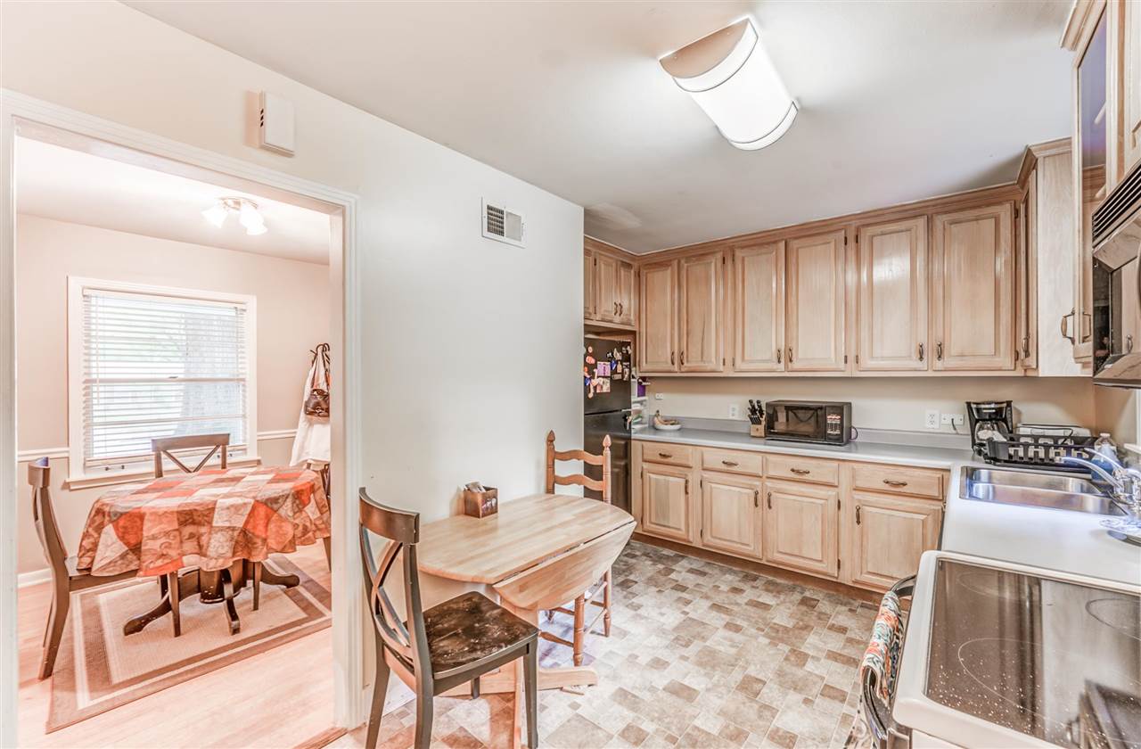 1422 Wilbec Road Memphis, TN 38117 - Photo 8 of 22 a kitchen with a stove a sink and cabinets