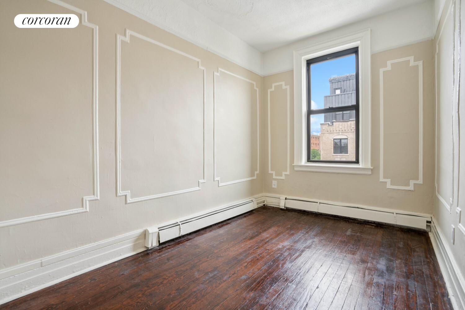 248 Rochester Avenue Brooklyn, NY 11213 - Photo 7 of 21 an empty room with wooden floor and windows