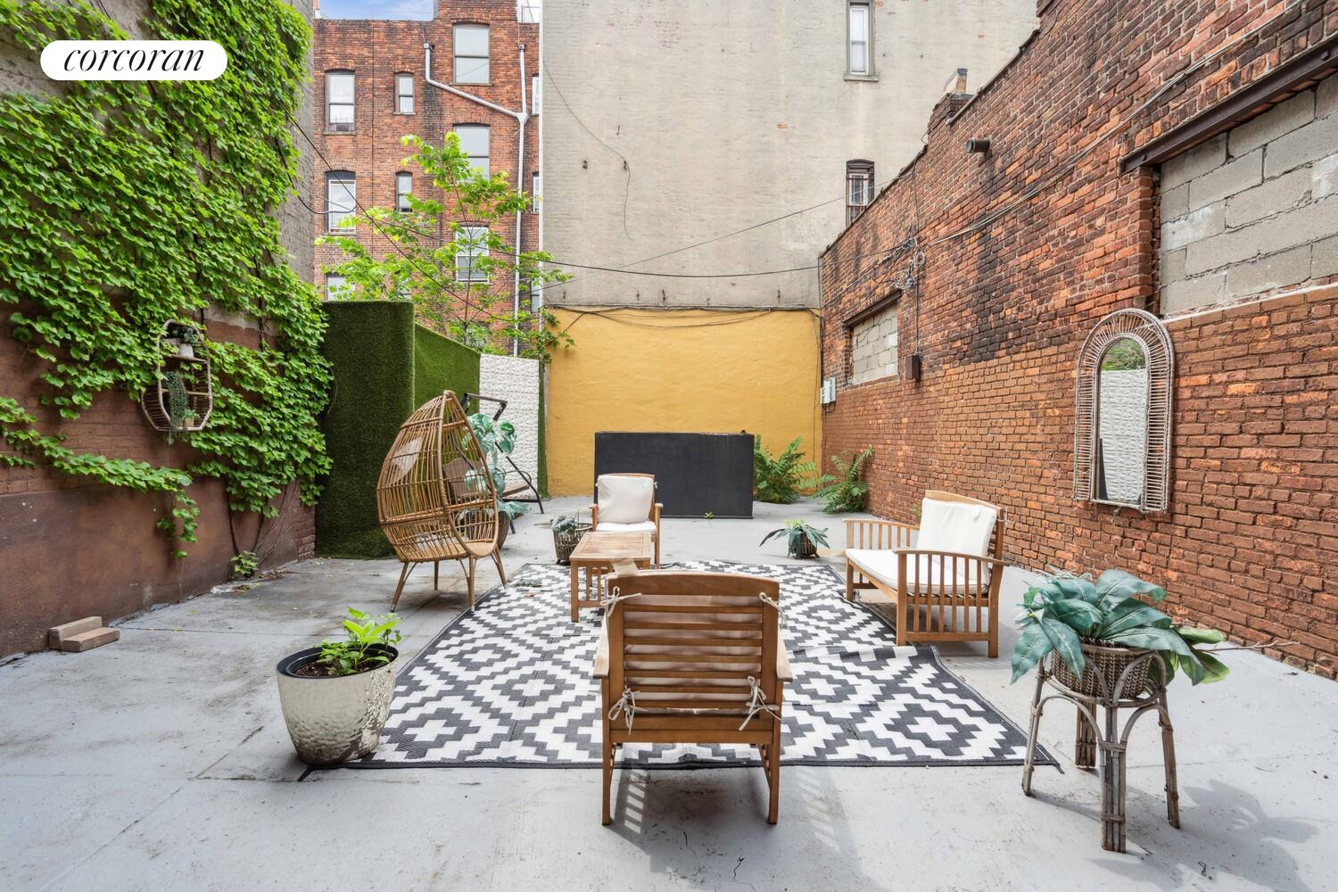 248 Rochester Avenue Brooklyn, NY 11213 - Photo 9 of 21 a view of a patio with table and chairs and potted plants