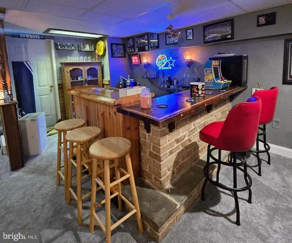 a dining room with furniture and a chandelier