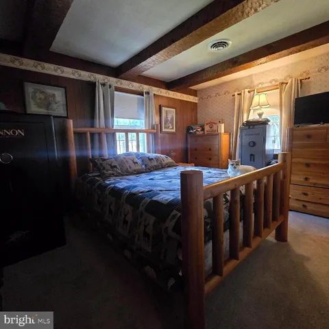 a bedroom with bed and wooden floor