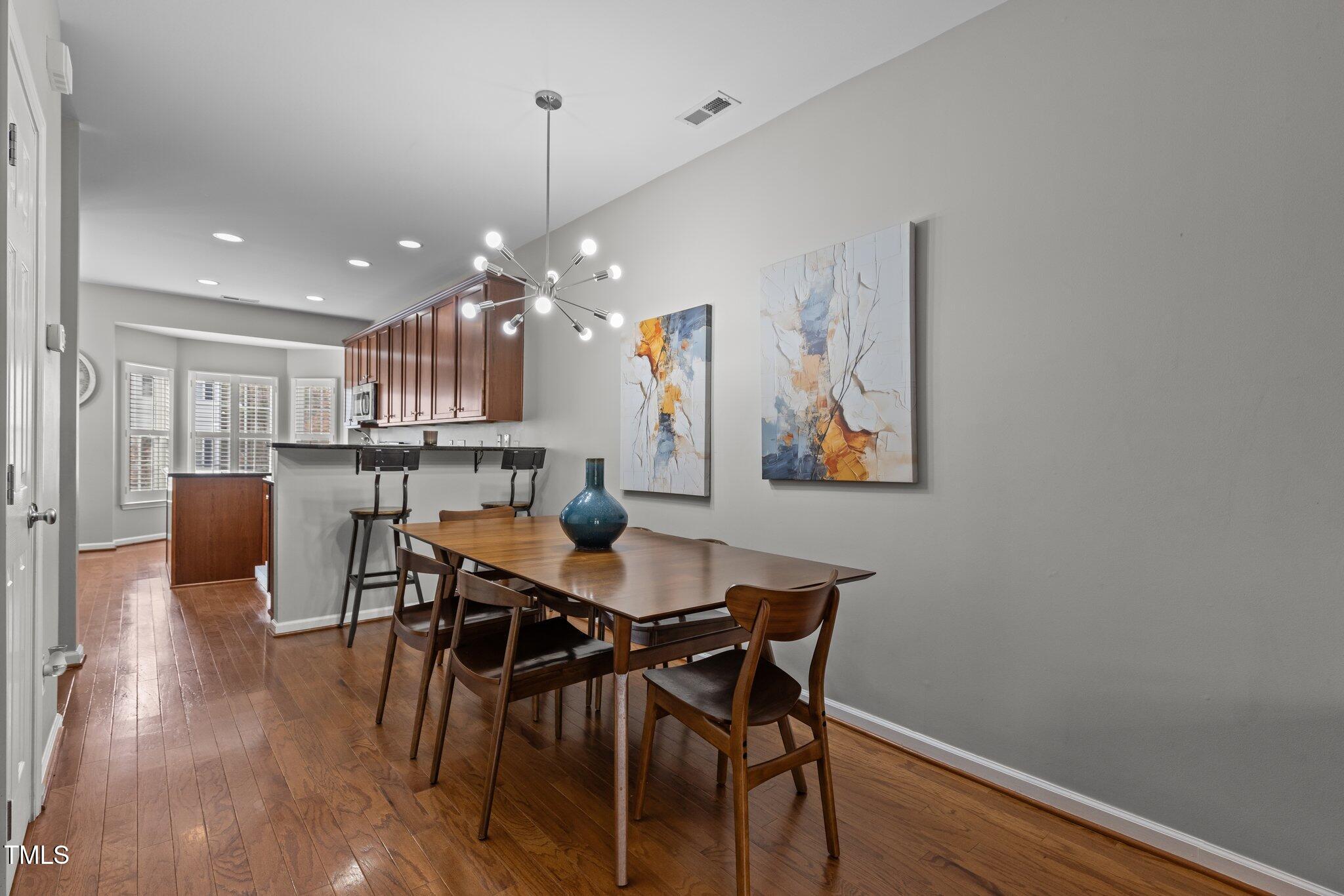 1667 Snow Mass Way Durham, NC 27713 - Photo 12 of 33 a view of a dining room with furniture and wooden floor