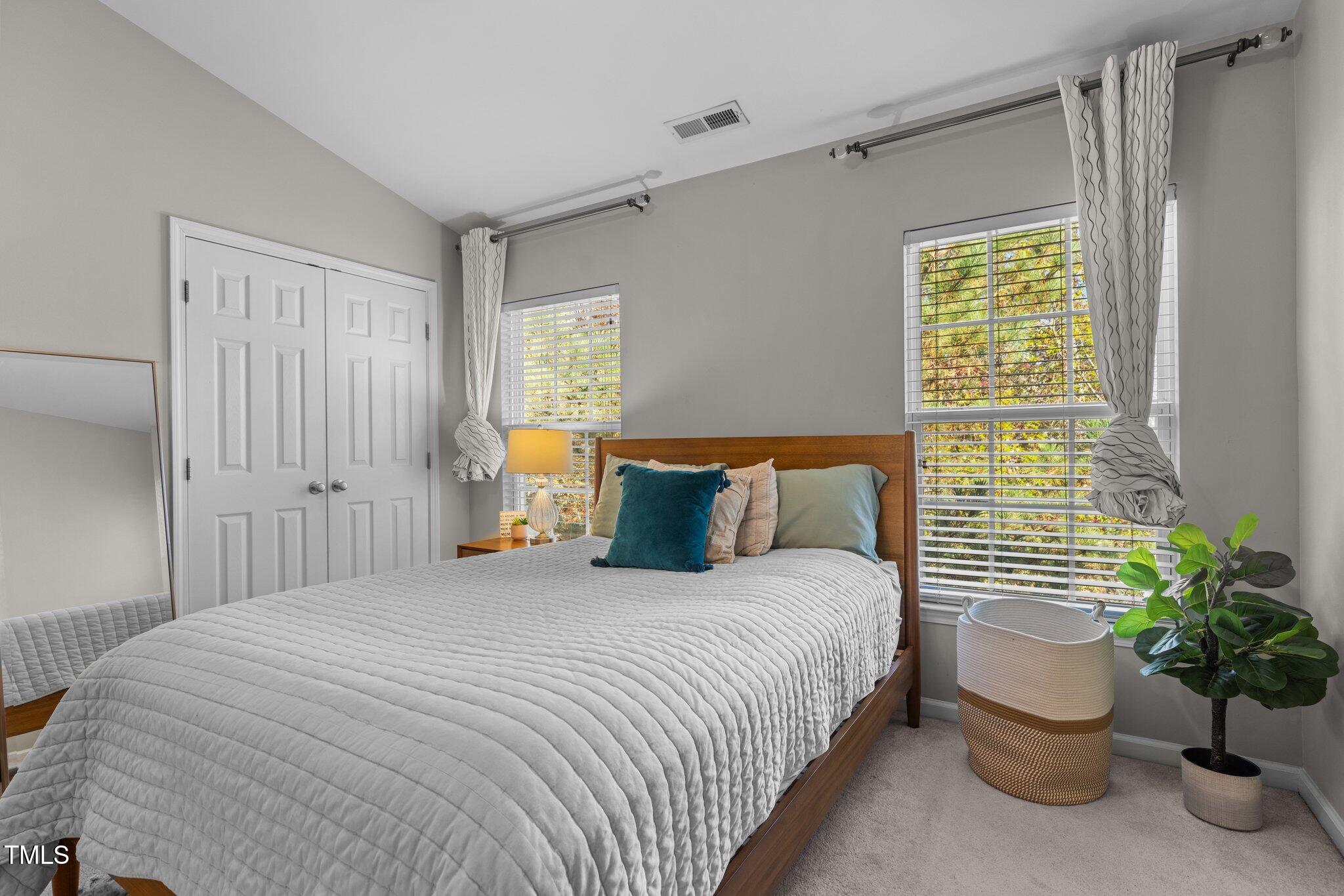 1667 Snow Mass Way Durham, NC 27713 - Photo 19 of 33 a bedroom with a bed and potted plant