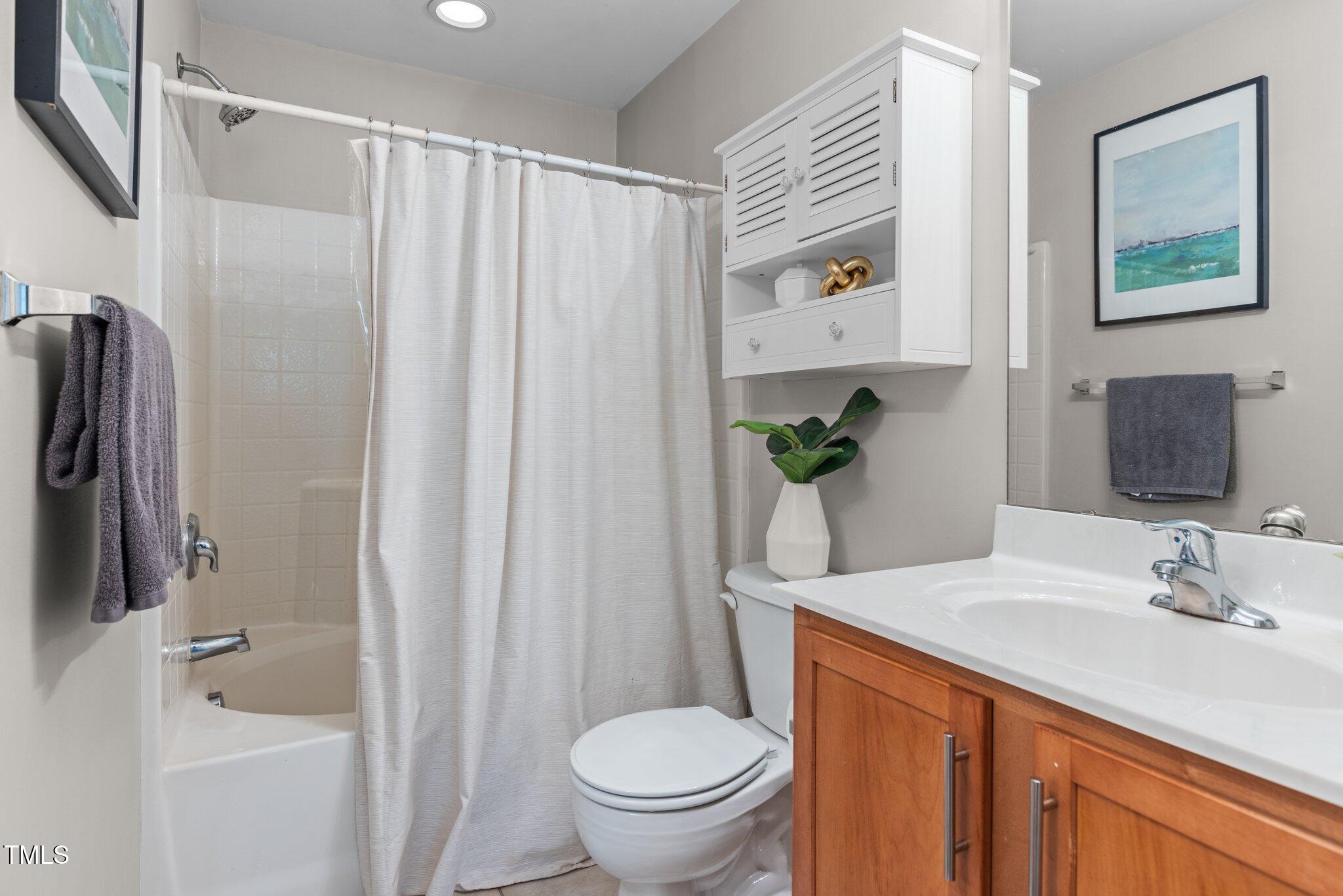 1667 Snow Mass Way Durham, NC 27713 - Photo 21 of 33 a bathroom with a granite countertop sink toilet and shower
