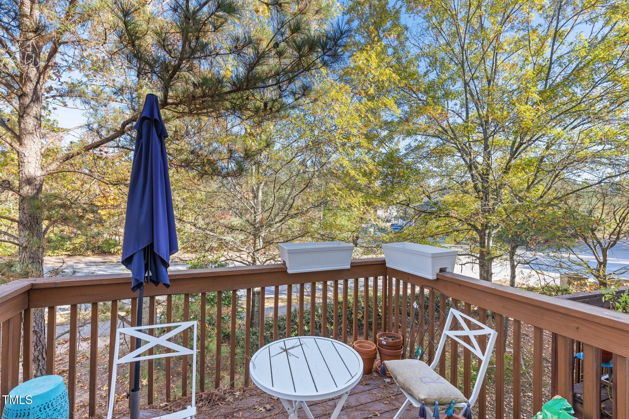 1667 Snow Mass Way Durham, NC 27713 - Photo 25 of 33 a front view of a brick house with large trees and wooden fence