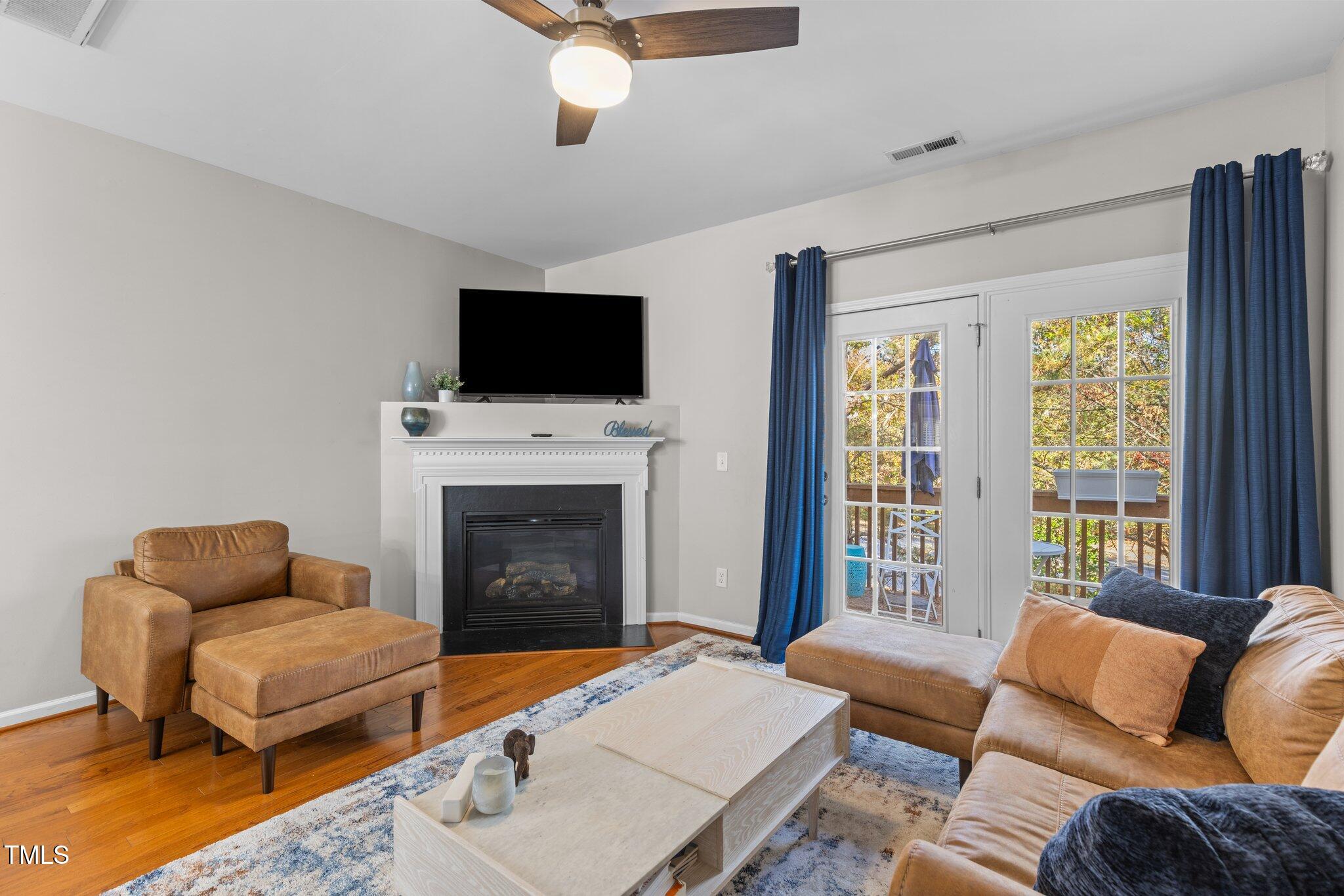 1667 Snow Mass Way Durham, NC 27713 - Photo 3 of 33 a living room with furniture a flat screen tv and a fireplace