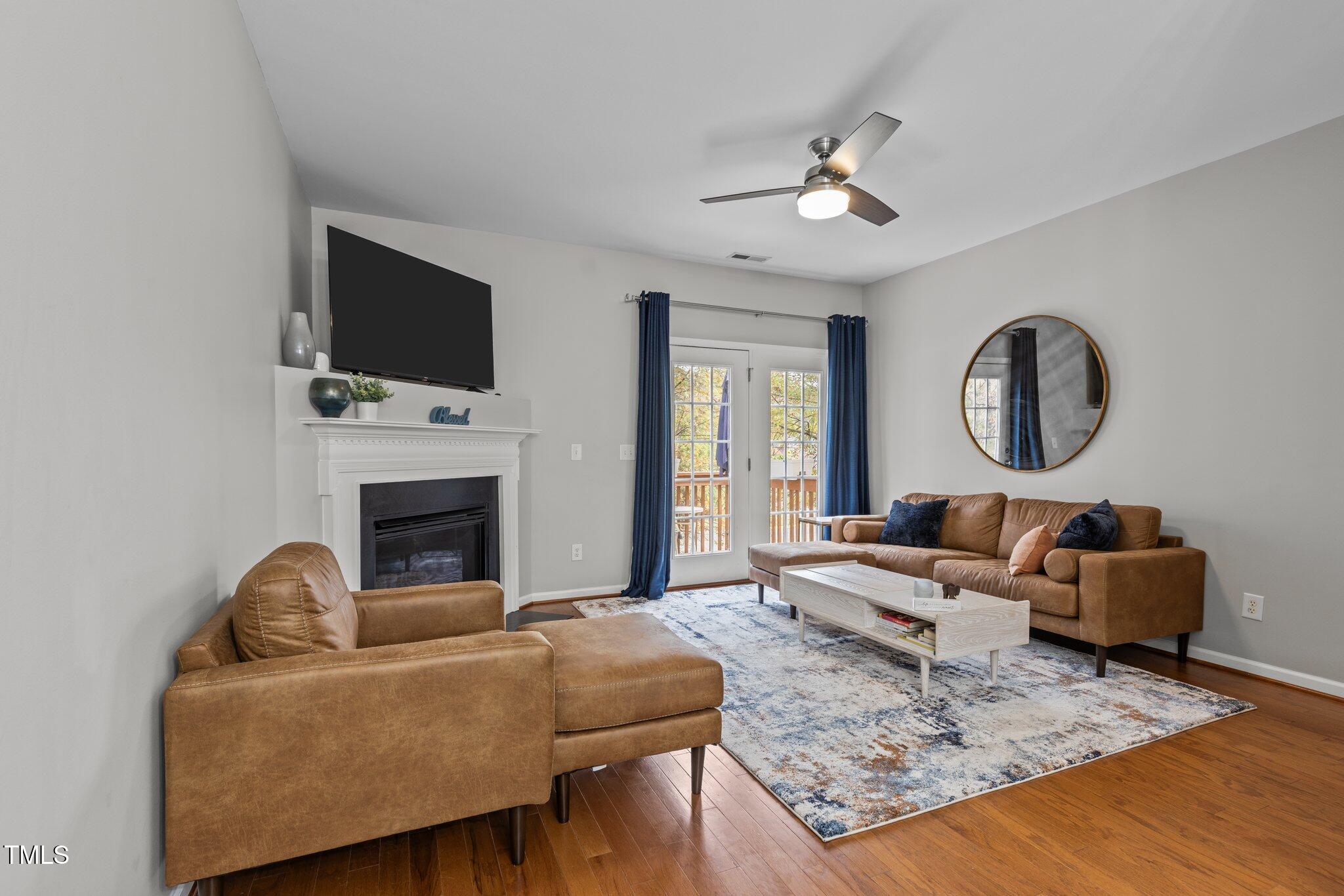 1667 Snow Mass Way Durham, NC 27713 - Photo 4 of 33 a living room with furniture a fireplace and a flat screen tv