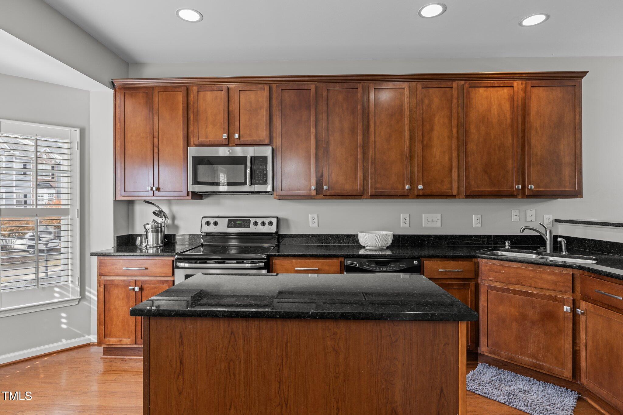 1667 Snow Mass Way Durham, NC 27713 - Photo 8 of 33 a kitchen with a sink a stove and cabinets