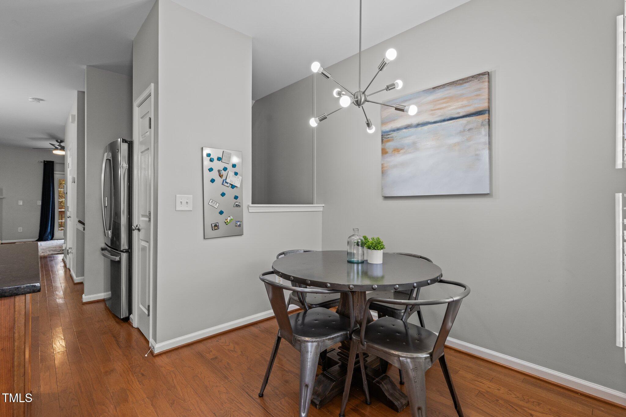 1667 Snow Mass Way Durham, NC 27713 - Photo 10 of 33 a view of a dining room with furniture and wooden floor