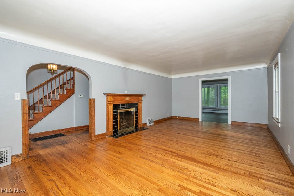 272 Ewing Road Youngstown, OH 44512 - Photo 6 of 19 Living room featuring tile fireplace and newly refinished hardwood floors