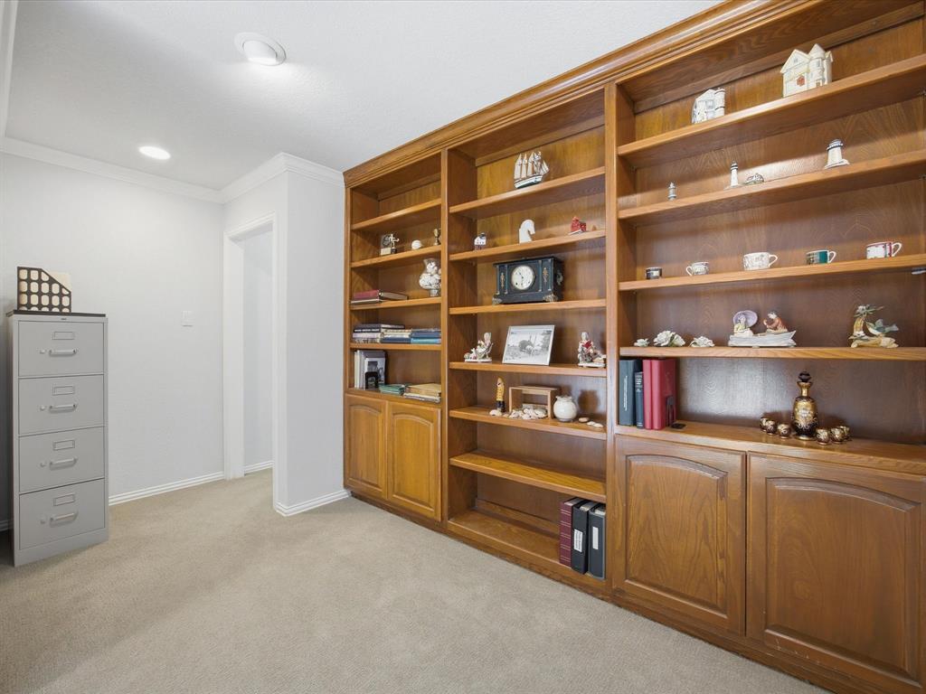 10106 Ravenswood Road Granbury, TX 76049 - Photo 17 of 39 a room with furniture and a book shelf