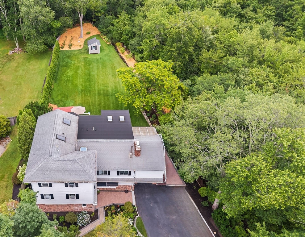an aerial view of a house with a yard and lake view