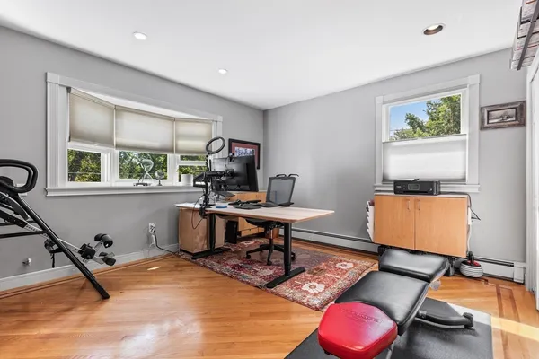 a room with furniture gym equipment and a window
