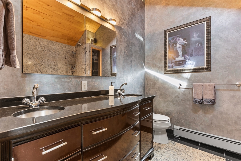 409 Haverhill Street Reading, MA 01867 - Photo 19 of 42 a bathroom with a sink and a mirror