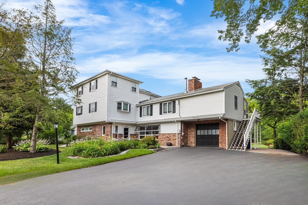 409 Haverhill Street Reading, MA 01867 - Photo 2 of 42 a view of house and yard with green space