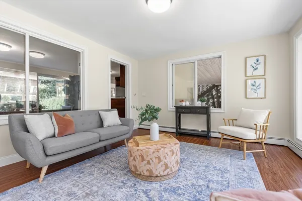 a living room with furniture and wooden floor