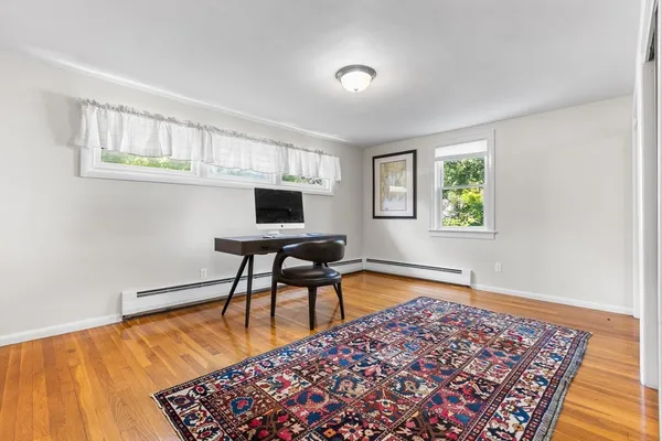 a workspace room with furniture and a rug