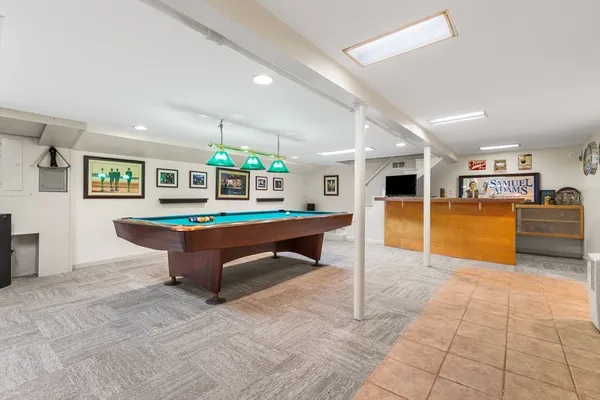 a living room with furniture a table and kitchen view