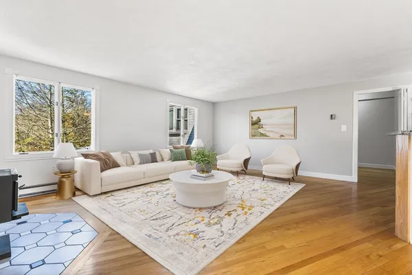 a living room with furniture a window and a table