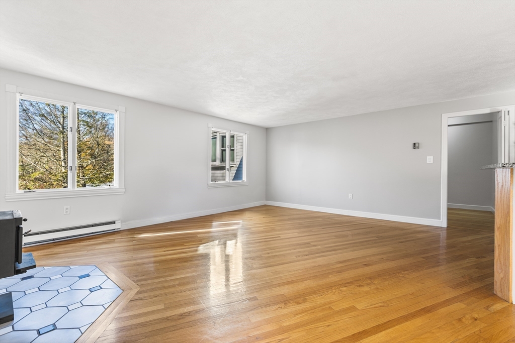 409 Haverhill Street Reading, MA 01867 - Photo 32 of 42 a view of empty room with wooden floor and fan