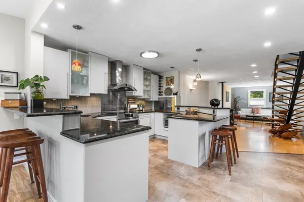 a kitchen with a table chairs refrigerator and cabinets