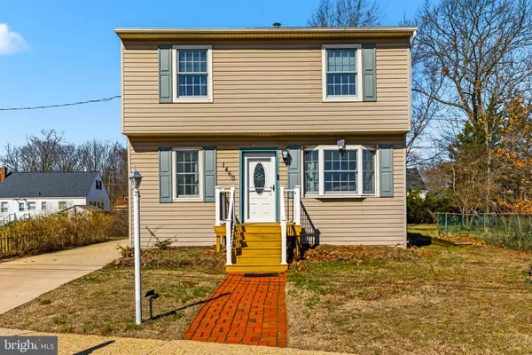 a view of a house with wooden fence