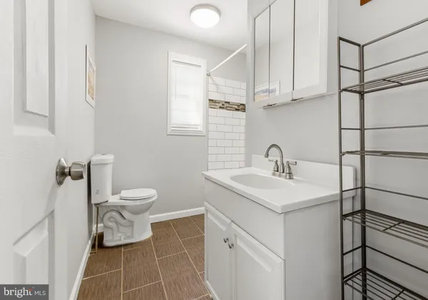 a bathroom with a sink toilet and a mirror