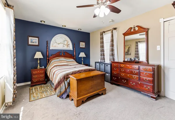 a bedroom with a bed and a dresser in it