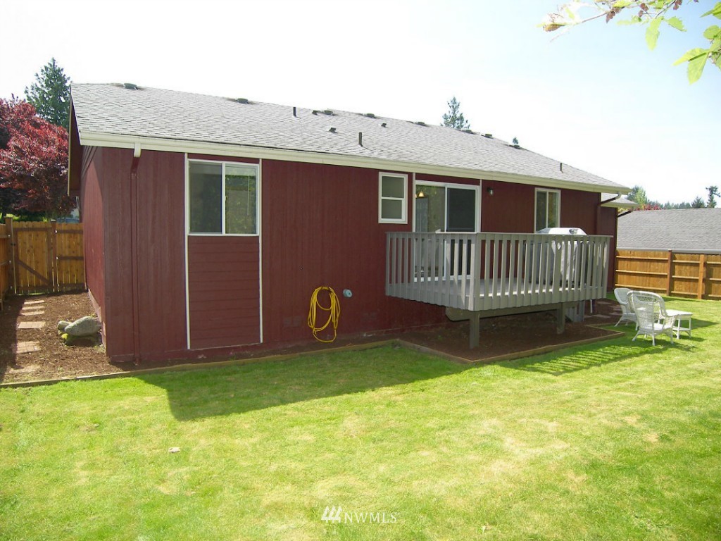 1496 Roma Road Bellingham, WA 98226 - Photo 12 of 14 a front view of a house with a garden and deck
