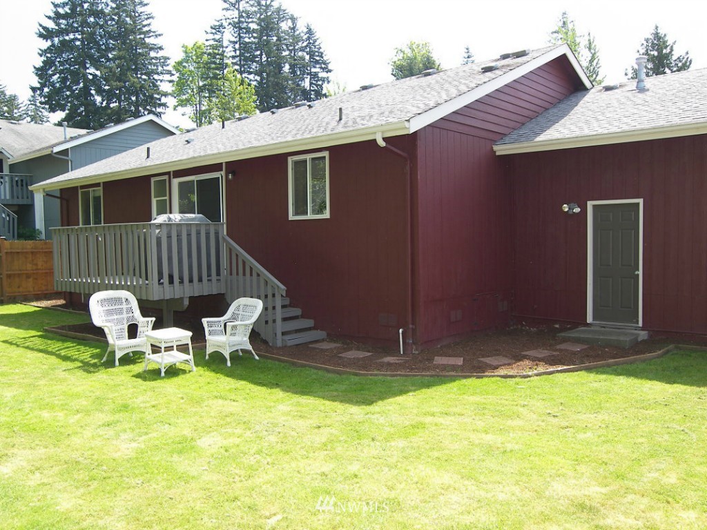 1496 Roma Road Bellingham, WA 98226 - Photo 13 of 14 a view of a chair and table in backyard of the house