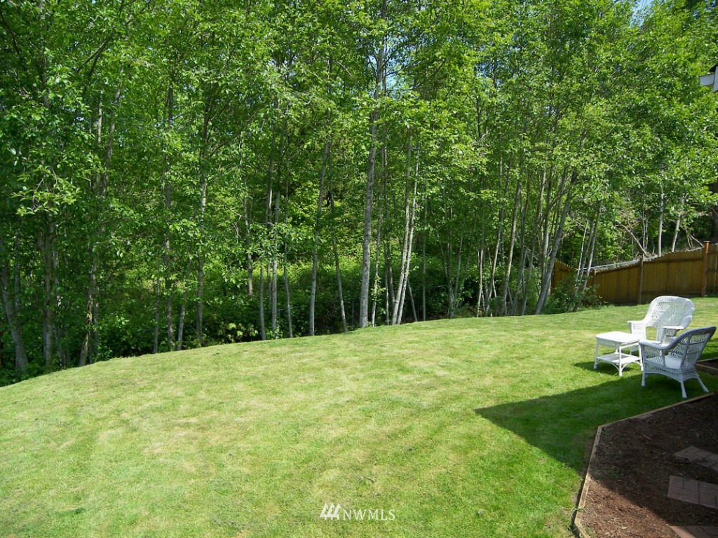 1496 Roma Road Bellingham, WA 98226 - Photo 14 of 14 a backyard of a house with table and chairs