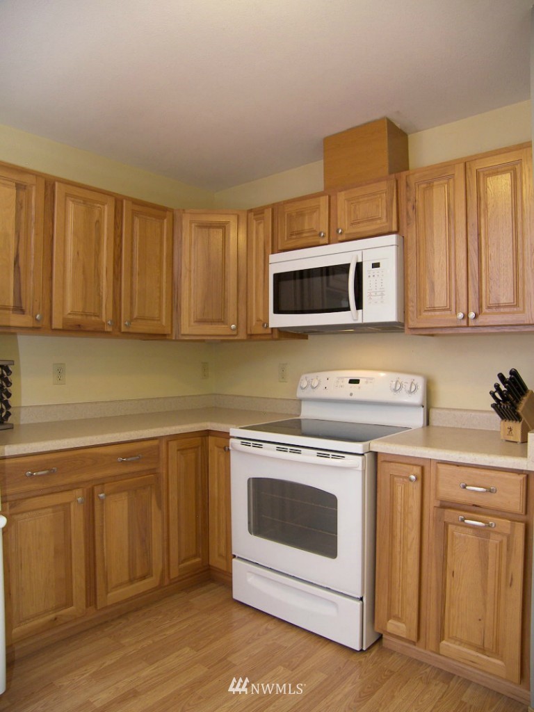 1496 Roma Road Bellingham, WA 98226 - Photo 5 of 14 a kitchen with cabinets appliances and a sink