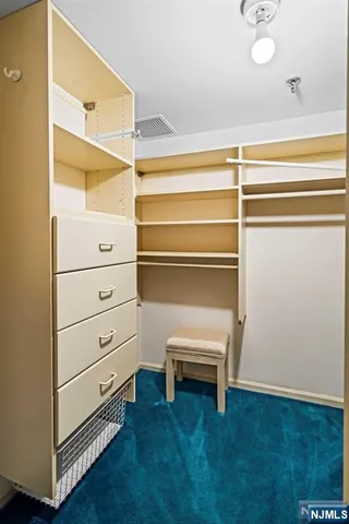 a room with gym equipment and large mirror